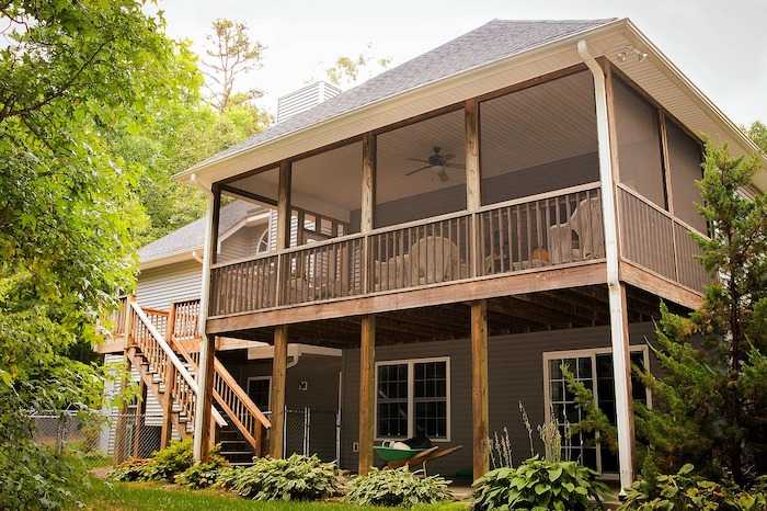 upper level enclosed deck with fly screens and railings